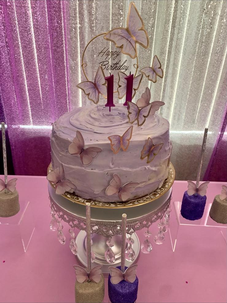 Purple ombre buttercream cake with edible butterflies and a gold-rimmed Happy Birthday topper for an 11th birthday