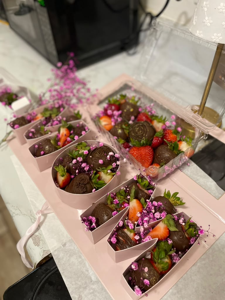 Assorted chocolate covered strawberry gift boxes finished with baby's breath and rolled chocolate roses