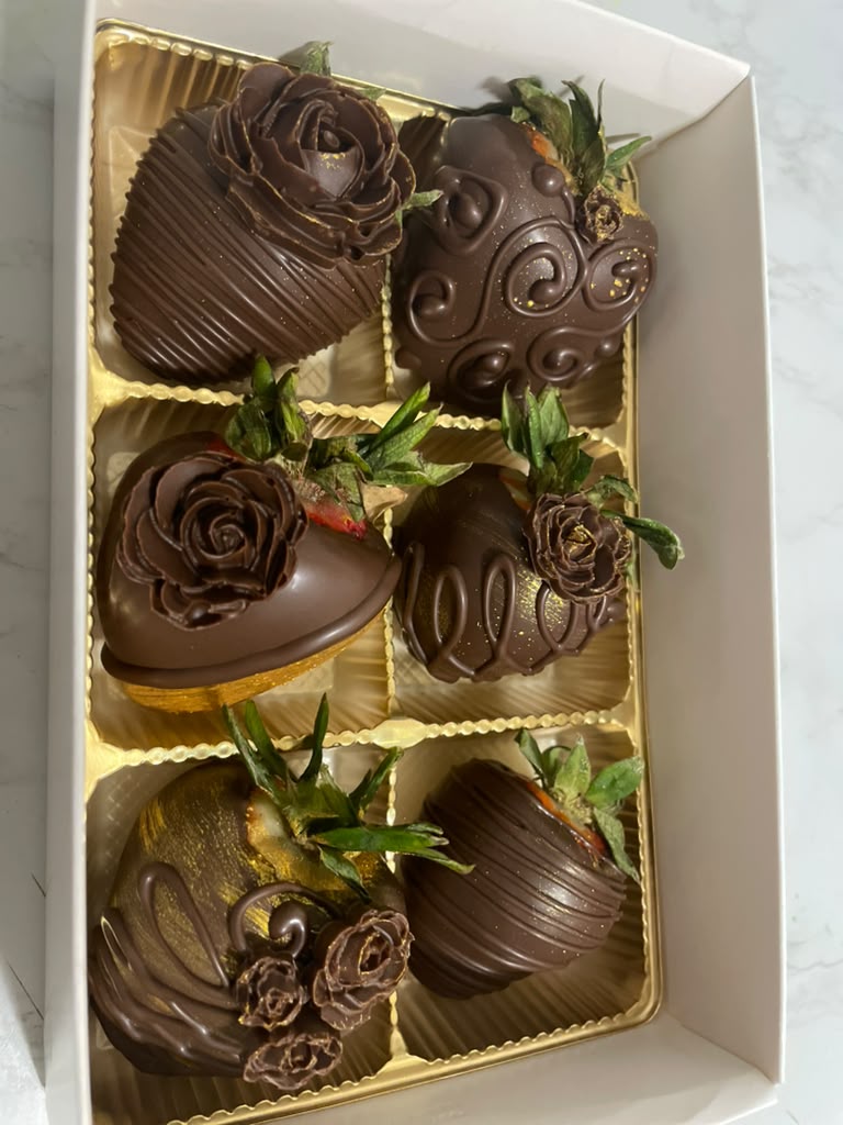 Elegant chocolate covered strawberries finished with piped chocolate roses and gold filigree
